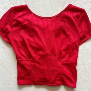 Short sleeve crop top with criss cross back. Size M. Color Red